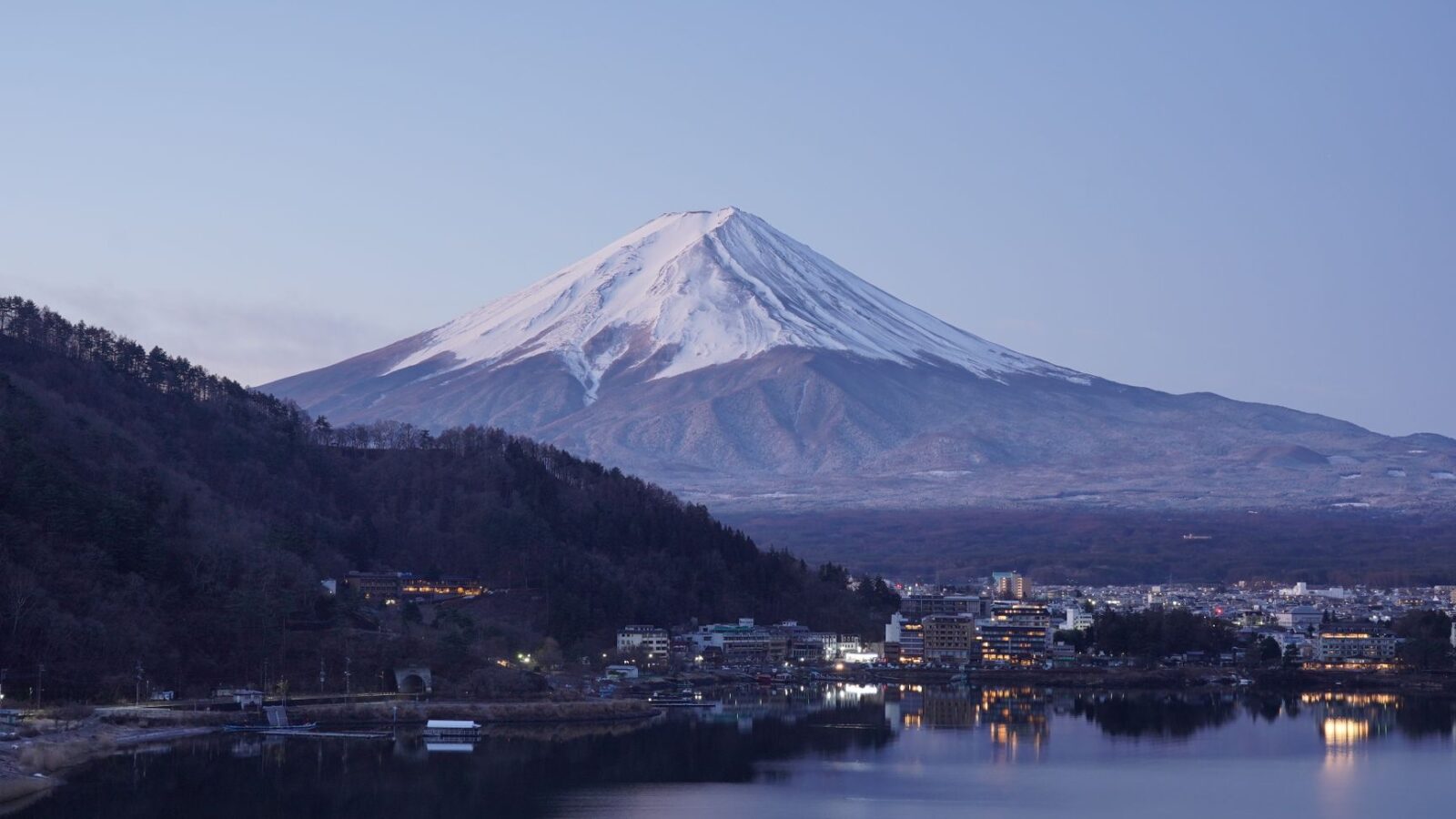 Peaceful twilight view of snow-capped Mount Fuji overlooking Kawaguchiko, Japan.