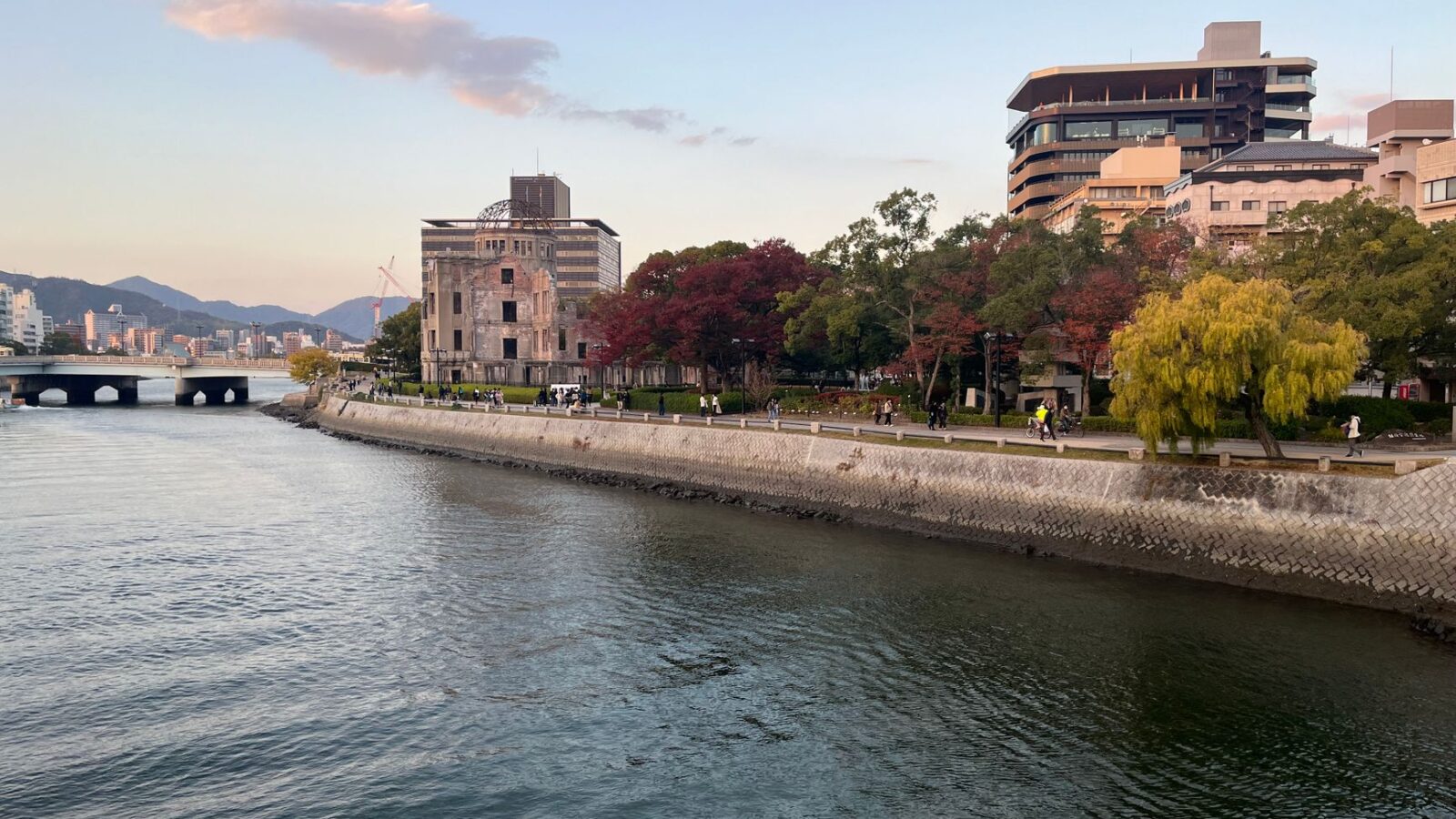 Scenic view of Hiroshima Peace Memorial Park with autumn foliage along the river.