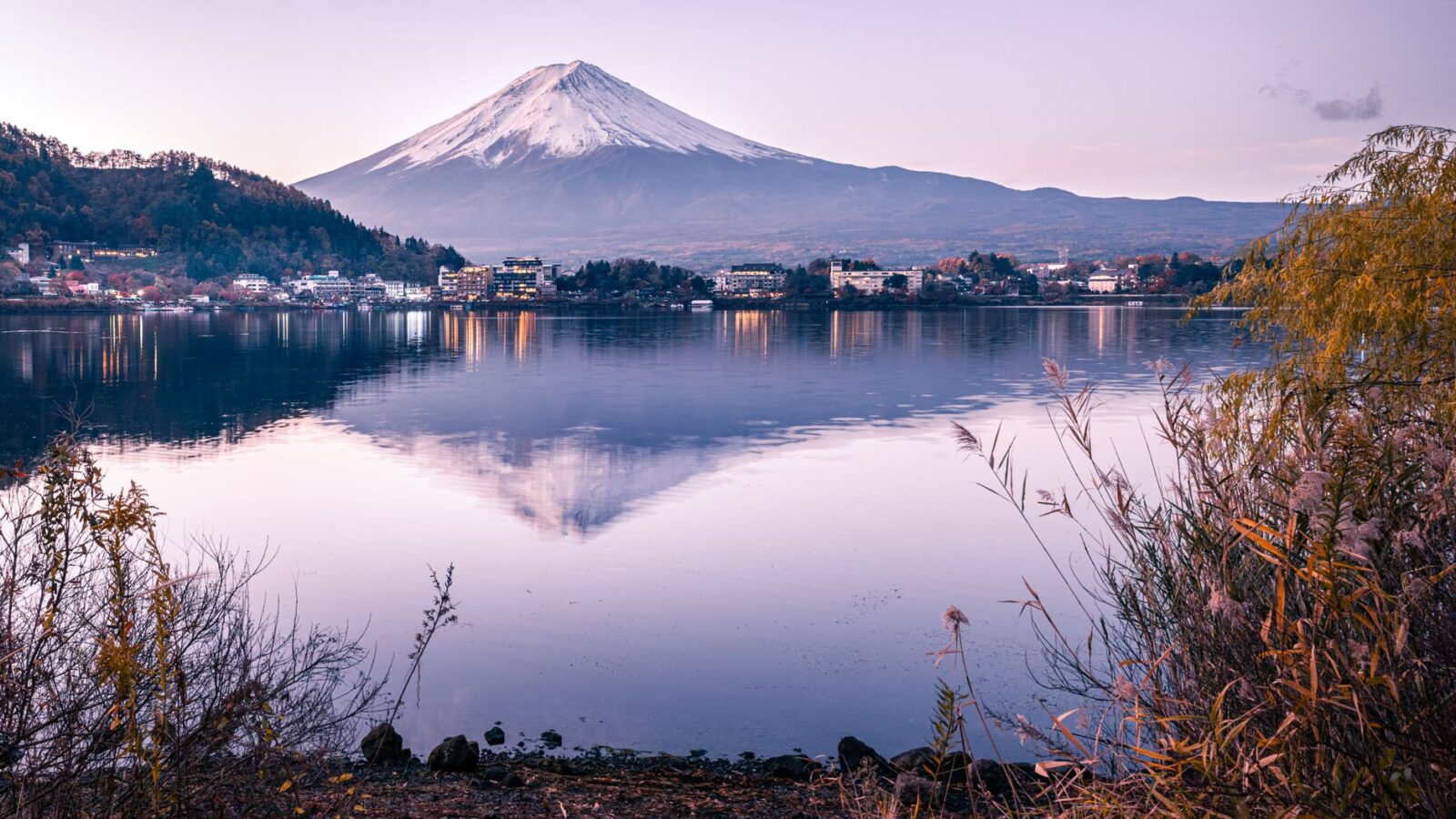 Serene reflection of Mount Fuji on Lake Kawaguchiko during dawn in Japan.