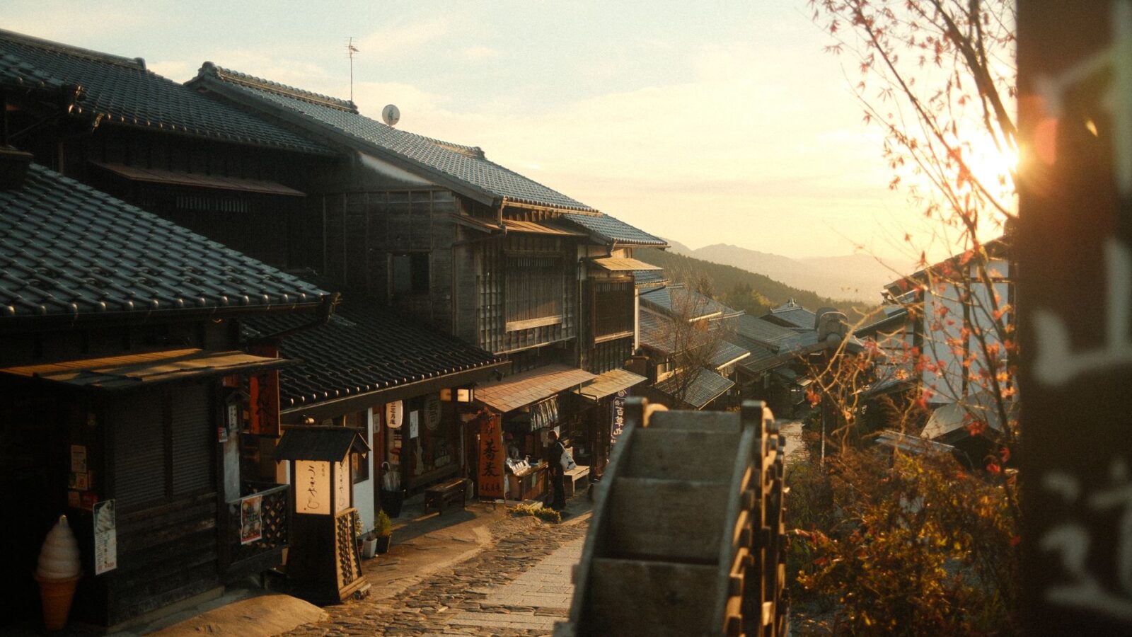 Peaceful traditional Japanese street illuminated by warm sunset, showcasing historic architecture.